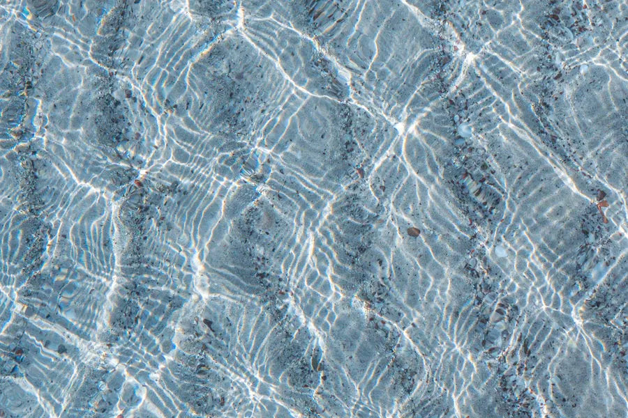 Sunlight rippling across clear water